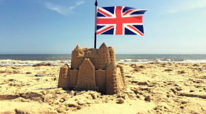 Sand castle at the beach with Union Jack 